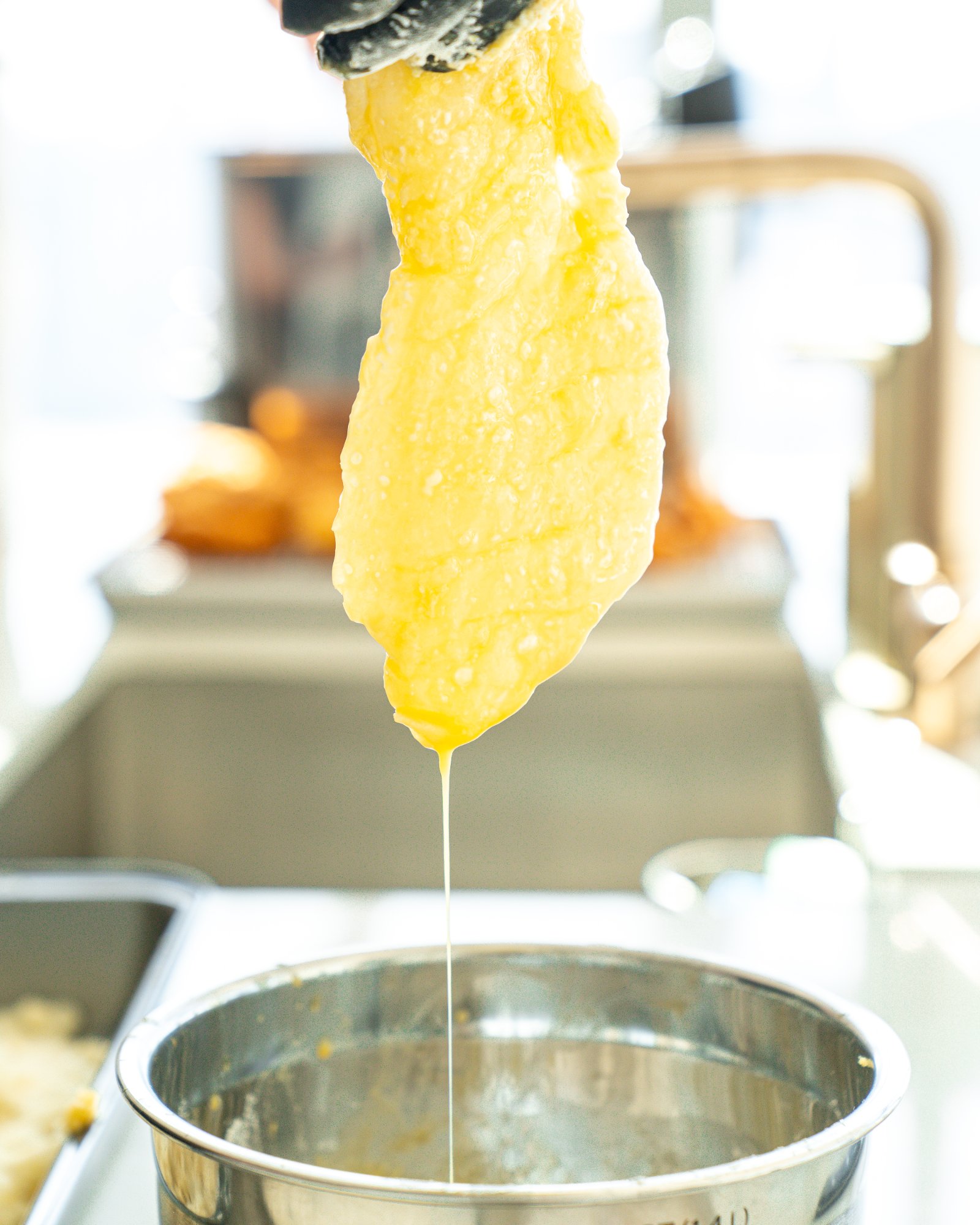 Battered cod dripping over the bowl