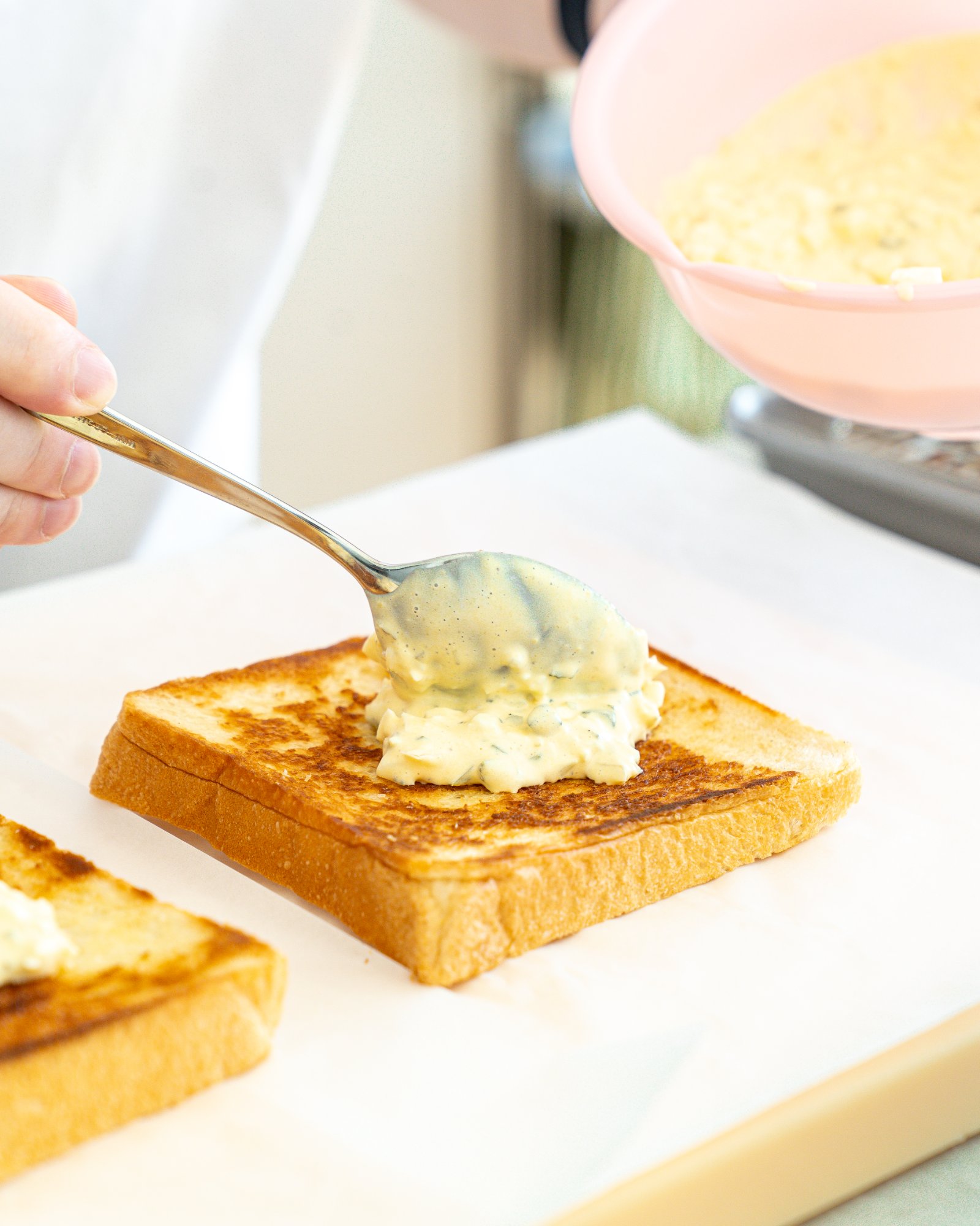 Spooning house tartar onto toasted shokupan