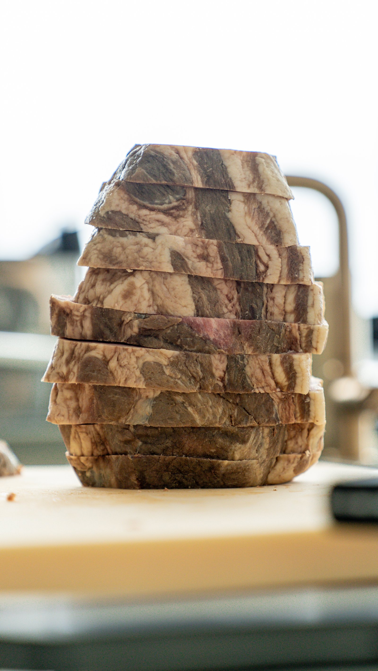 Stack of sliced pork collar showing the marbled kata-rosu cross-section